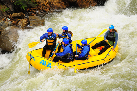 Group of people enjoying the Gold Rush Clear Creek whitewater rafting adventure in Idaho Springs, Colorado, which is available for free at Xplorie participating properties.