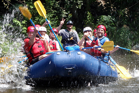 A group of people enjoy an exhilarating white water rafting adventure from Big Creek Expeditions in Tennessee, which is available for free to guests staying at Xplorie participating properties.