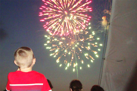 Passengers enjoy a free fireworks dolphin cruise aboard the Cattywampus in Fort Walton Beach, Florida, which is available for free to guests staying at Xplorie participating properties.