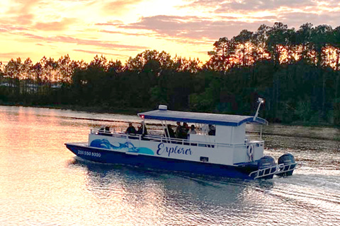 Group of people enjoying a beautiful sunset sailing adventure in Orange Beach, Alabama aboard Cetacean Cruises with a free admission from Xplorie.