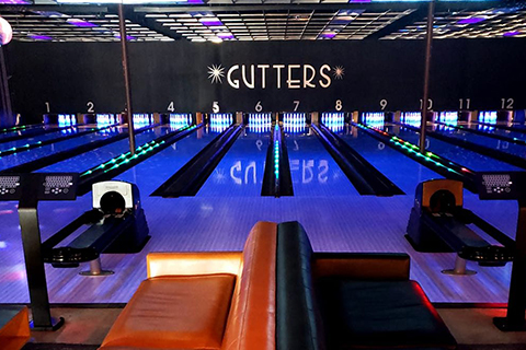 A view of the bowling alleys at Gutters in Taos, new Mexico, where guests staying at Xplorie participating properties can enjoy a free bowling game.