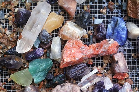 An assortment of gems that were panned at the Outpost Gold & Gem in Helen, Georgia, where guests staying at Xplorie participating properties can receive a free 1-Gallon Gem Bucket.