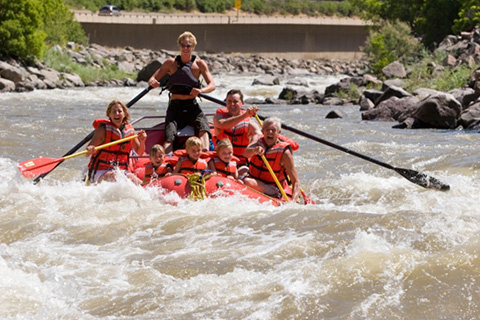 A group of people enjoy a thrilling river rafting adventure from Park City Rafting in Morgan, Utah, which is available for free to guests staying at Xplorie participating properties.