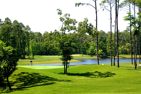 A man golfs on the serenely beautiful golf course at Tupelo Bay Golf Center in Garden City, South Carolina, where guests staying at Xplorie participating properties can enjoy a free round of eighteen hole golf.
